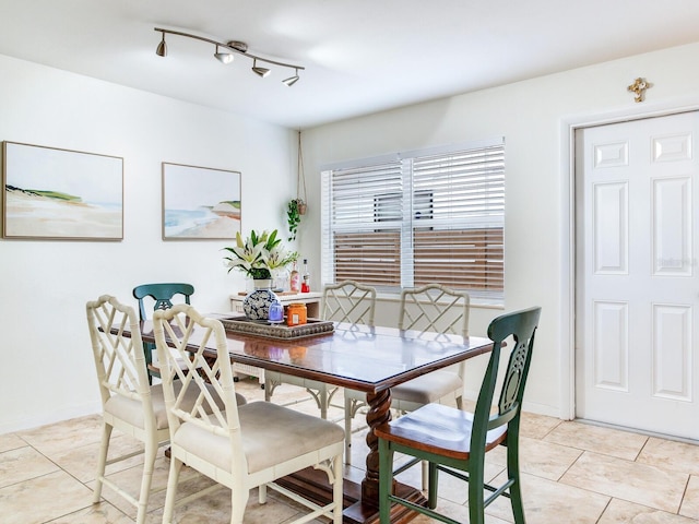 1700 25th St N, Saint Petersburg, FL 33713 - dining room featuring baseboards, rail lighting, and light tile patterned flooring