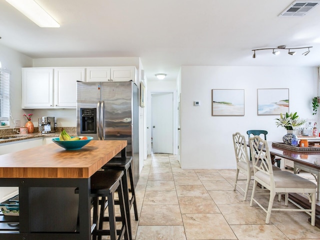 1700 25th St N, Saint Petersburg, FL 33713 - kitchen with white cabinetry, visible vents, wooden counters, and a sink