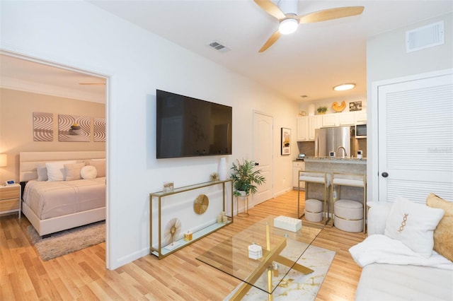 10473 Villa View Cir, Tampa, FL 33647 - living room with baseboards, ceiling fan, light wood finished floors, and visible vents