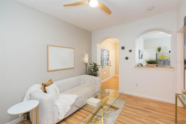 10473 Villa View Cir, Tampa, FL 33647 - living room with baseboards, arched walkways, ceiling fan, and wood finished floors