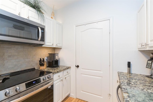 10473 Villa View Cir, Tampa, FL 33647 - kitchen with white cabinetry and appliances with stainless steel finishes