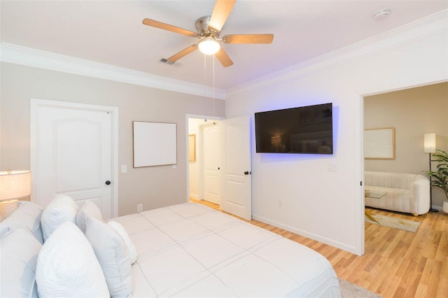 10473 Villa View Cir, Tampa, FL 33647 - bedroom with visible vents, ornamental molding, baseboards, a ceiling fan, and light wood finished floors