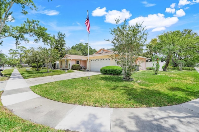 view of front of house with fence, an attached garage, a front lawn, stucco siding, and concrete driveway
