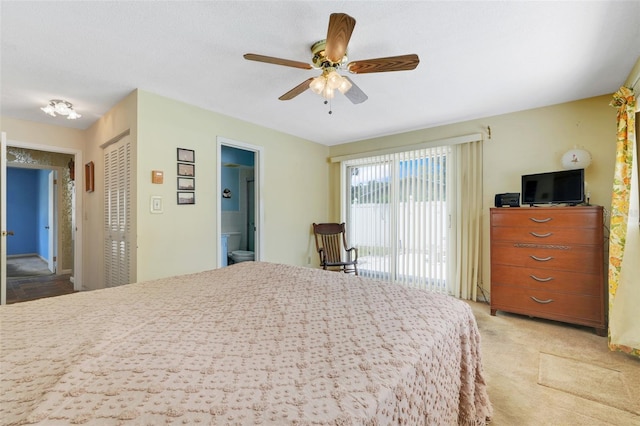 bedroom featuring access to outside, light carpet, ensuite bath, a ceiling fan, and a closet