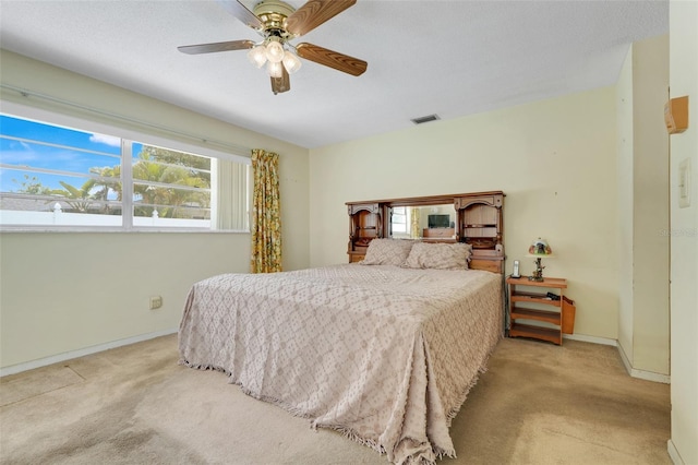 bedroom featuring carpet floors, baseboards, ceiling fan, and visible vents