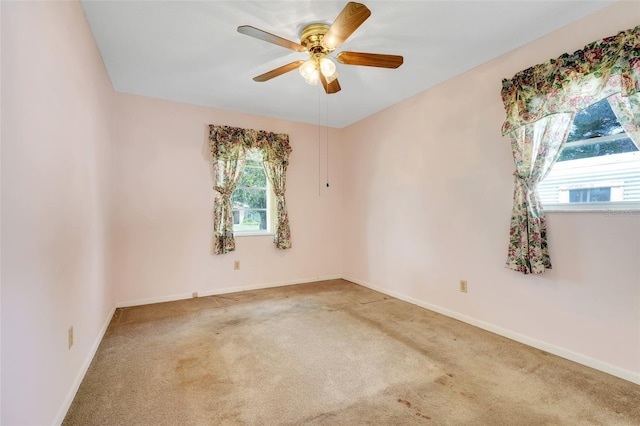 unfurnished room with baseboards, ceiling fan, and carpet flooring