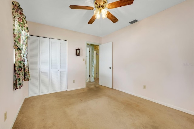 unfurnished bedroom with visible vents, a ceiling fan, a closet, baseboards, and carpet flooring
