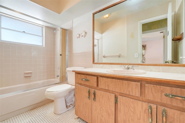 full bathroom with vanity, toilet, tile patterned floors, tile walls, and shower / bathing tub combination