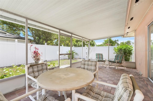 sunroom featuring outdoor dining space