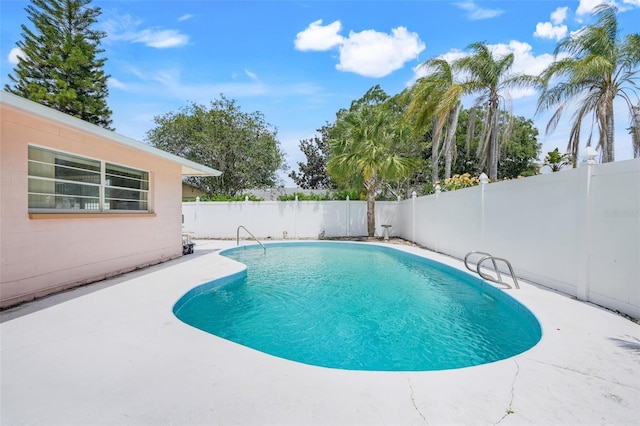 view of swimming pool featuring a fenced in pool, a fenced backyard, and a patio