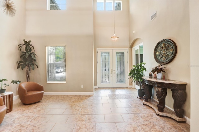 3243 Watermark Dr, Wesley Chapel, FL 33544 - tiled entrance foyer featuring baseboards, french doors, visible vents, and a high ceiling