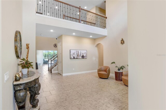 3243 Watermark Dr, Wesley Chapel, FL 33544 - interior space with recessed lighting, baseboards, tile patterned flooring, arched walkways, and a high ceiling