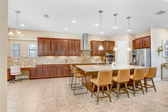 3243 Watermark Dr, Wesley Chapel, FL 33544 - kitchen with light stone counters, decorative backsplash, visible vents, and wall chimney exhaust hood