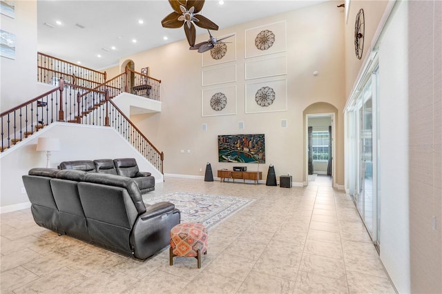 3243 Watermark Dr, Wesley Chapel, FL 33544 - living area featuring a high ceiling, stairs, ceiling fan, arched walkways, and recessed lighting