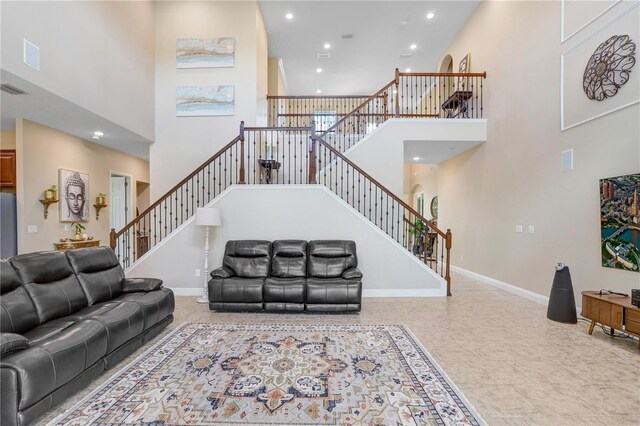 3243 Watermark Dr, Wesley Chapel, FL 33544 - living room featuring baseboards, stairs, recessed lighting, and a high ceiling