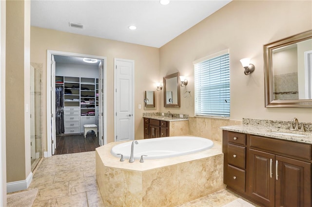 3243 Watermark Dr, Wesley Chapel, FL 33544 - bathroom with a sink, visible vents, a shower stall, a walk in closet, and a garden tub
