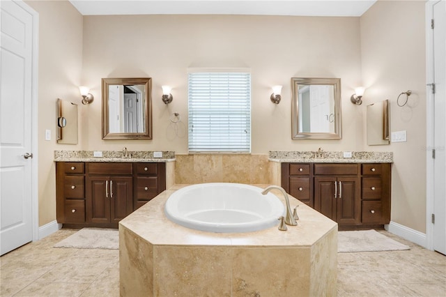 3243 Watermark Dr, Wesley Chapel, FL 33544 - bathroom with a garden tub, two vanities, and a sink