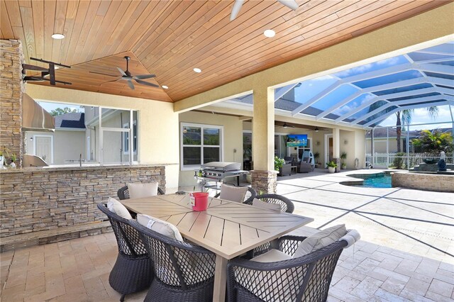 3243 Watermark Dr, Wesley Chapel, FL 33544 - view of patio featuring outdoor dining space, grilling area, a ceiling fan, and a hot tub