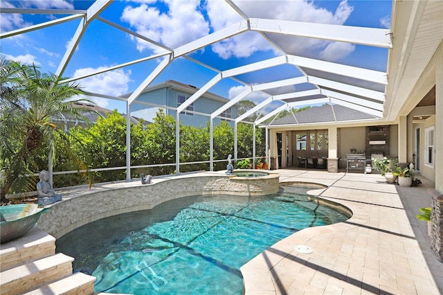 3243 Watermark Dr, Wesley Chapel, FL 33544 - view of pool featuring a pool with connected hot tub, a patio, and glass enclosure
