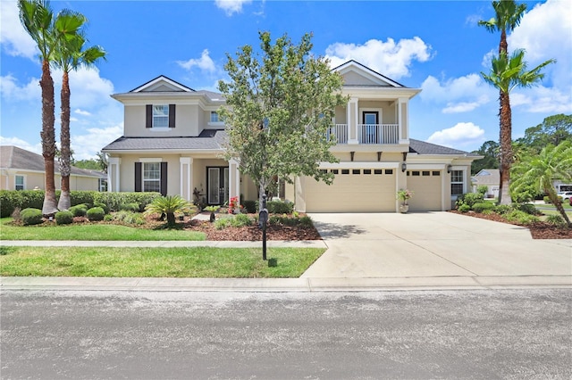 3243 Watermark Dr, Wesley Chapel, FL 33544 - view of front of house with an attached garage, stucco siding, driveway, and a balcony