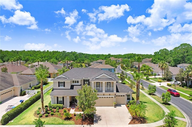3243 Watermark Dr, Wesley Chapel, FL 33544 - view of front facade featuring concrete driveway, stucco siding, a residential view, and an attached garage