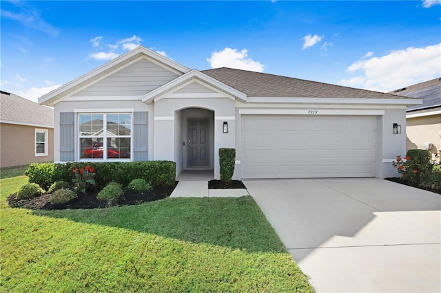 ranch-style home featuring a front yard, stucco siding, an attached garage, and driveway