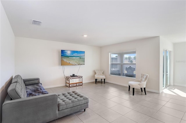 living area featuring light tile patterned floors, recessed lighting, baseboards, and visible vents