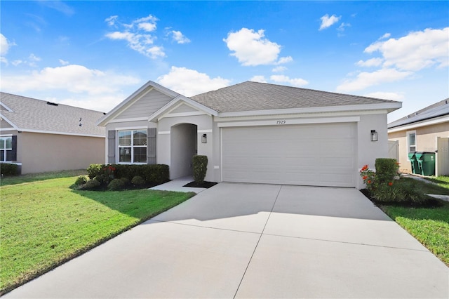 single story home featuring concrete driveway, an attached garage, stucco siding, and a front yard