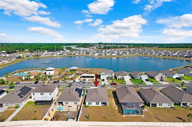 birds eye view of property featuring a water view and a residential view