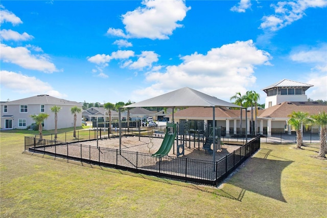 community play area with a yard and fence