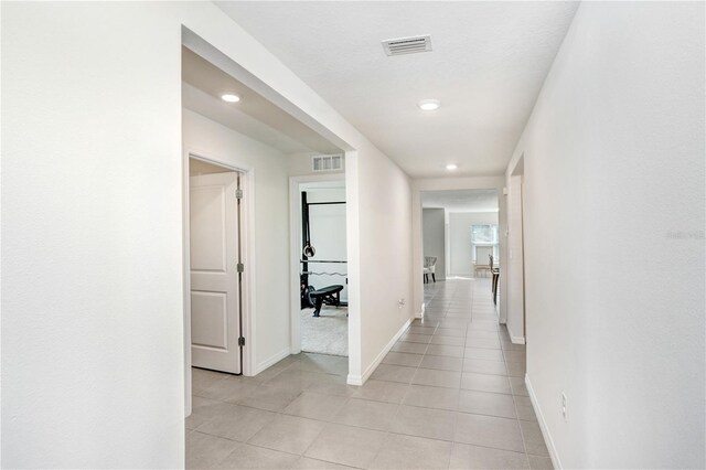 7929 Sail Clover Ln, Zephyrhills, FL 33540 - corridor featuring recessed lighting, baseboards, and light tile patterned floors