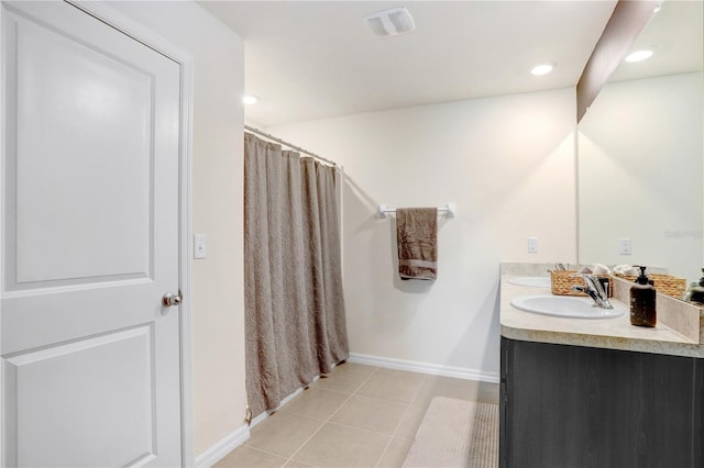 7929 Sail Clover Ln, Zephyrhills, FL 33540 - full bathroom with baseboards, double vanity, tile patterned floors, a shower with shower curtain, and recessed lighting