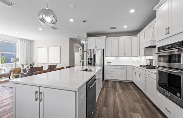 kitchen featuring decorative backsplash, white cabinets, visible vents, stainless steel appliances, and dark wood-type flooring
