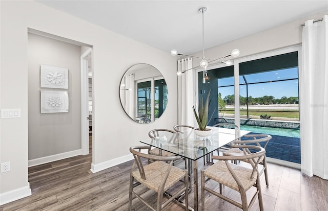 dining area with wood finished floors and baseboards