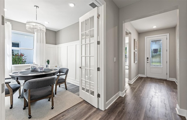 dining space with dark wood finished floors, visible vents, a chandelier, and recessed lighting