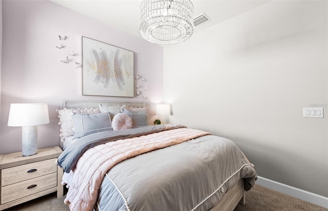 bedroom with baseboards, visible vents, a notable chandelier, and carpet