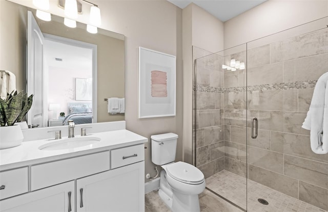 full bath with connected bathroom, visible vents, a stall shower, toilet, and vanity