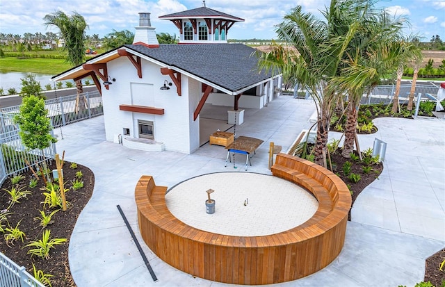 exterior space featuring a chimney, a patio, and fence