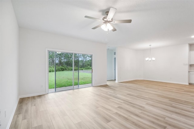 unfurnished living room featuring baseboards, light wood-style floors, and ceiling fan with notable chandelier