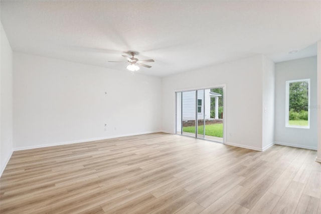 empty room with ceiling fan, baseboards, and light wood-style floors