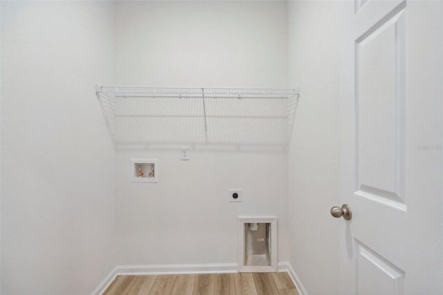 laundry room with hookup for an electric dryer, laundry area, hookup for a washing machine, light wood-style flooring, and baseboards