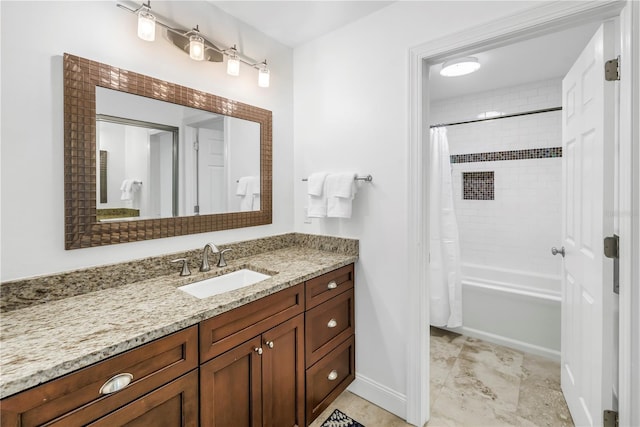 bathroom featuring vanity, baseboards, and shower / bath combo