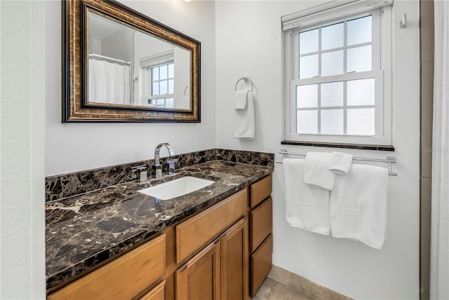 full bathroom with plenty of natural light and vanity
