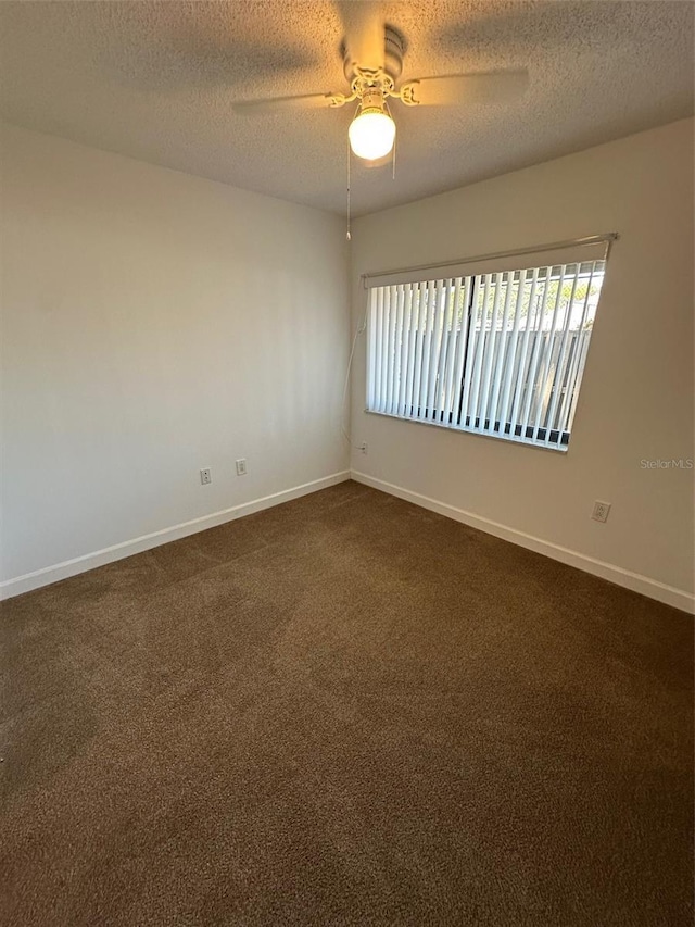 2055 Sunset Point Rd Unit 3804, Clearwater, FL 33765 - unfurnished room featuring baseboards, a ceiling fan, a textured ceiling, and dark colored carpet