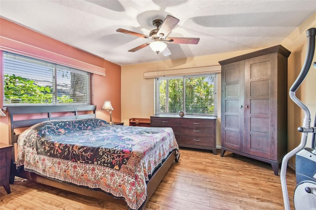 bedroom featuring light wood-style floors and a ceiling fan