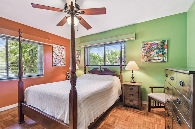 bedroom featuring baseboards and ceiling fan