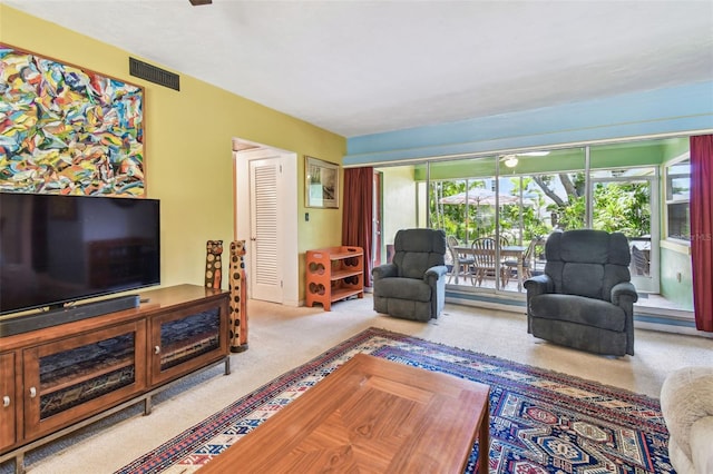 living area featuring carpet flooring and visible vents