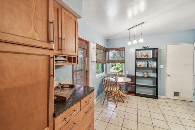 dining room with light tile patterned floors and baseboards