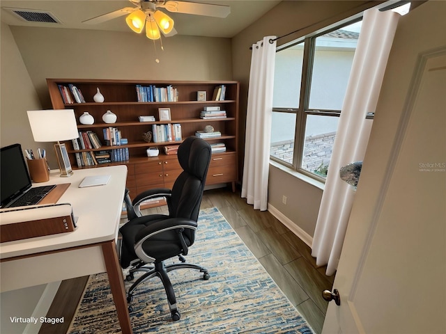 office space featuring ceiling fan, visible vents, and baseboards