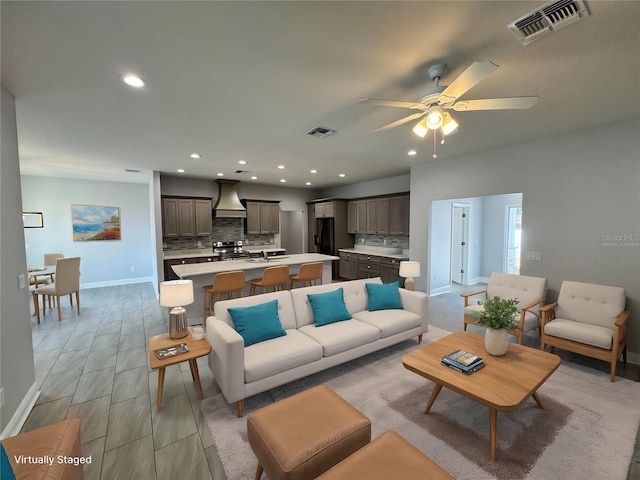 living room with baseboards, visible vents, ceiling fan, and recessed lighting